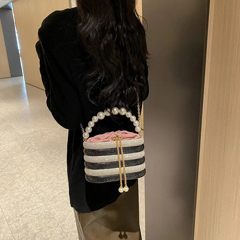 Women's retro style crossbody bag with pearl beads and rounded shape in soft PU material