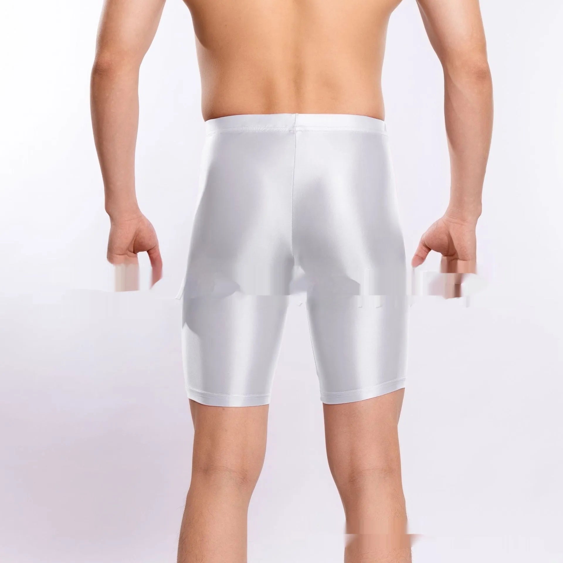 Man wearing shiny black plus size nylon sports shorts, showing silky finish.