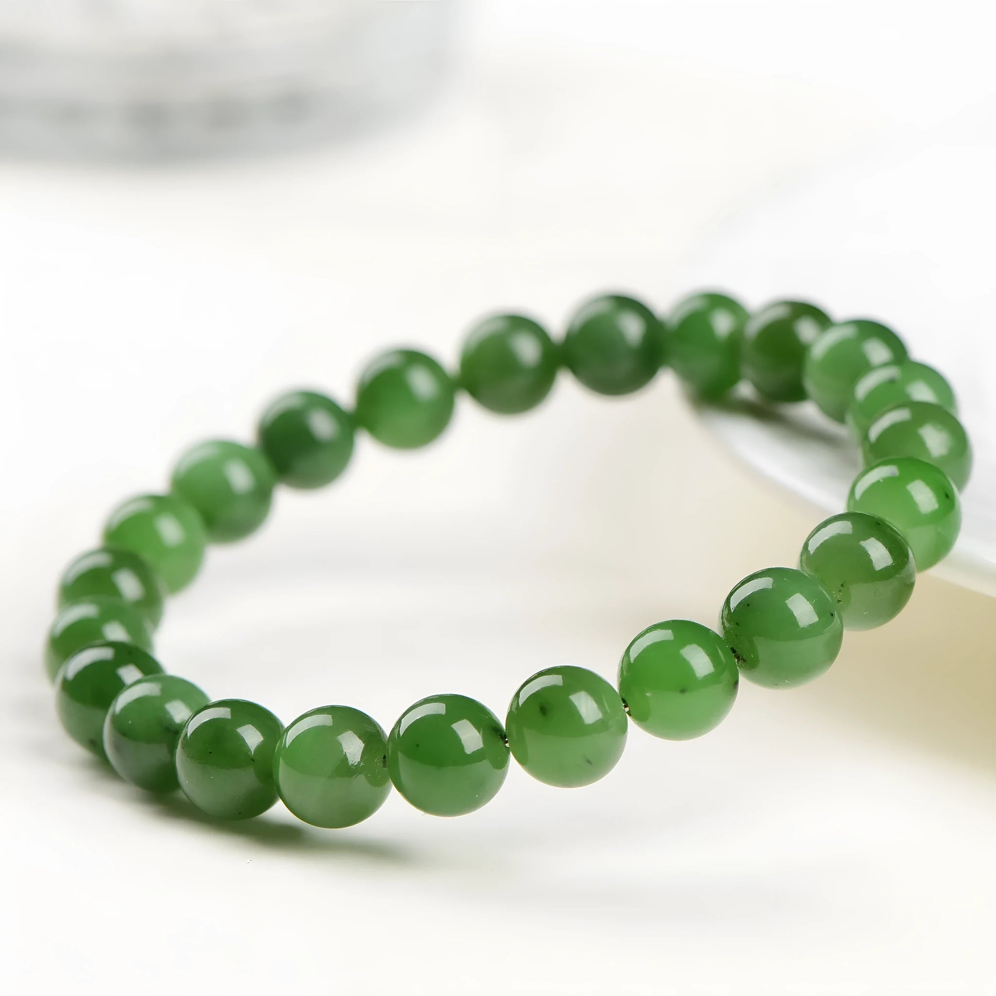 Natural jasper bead bracelet on wrist showing polished Hetian jade construction with multiple bead size options