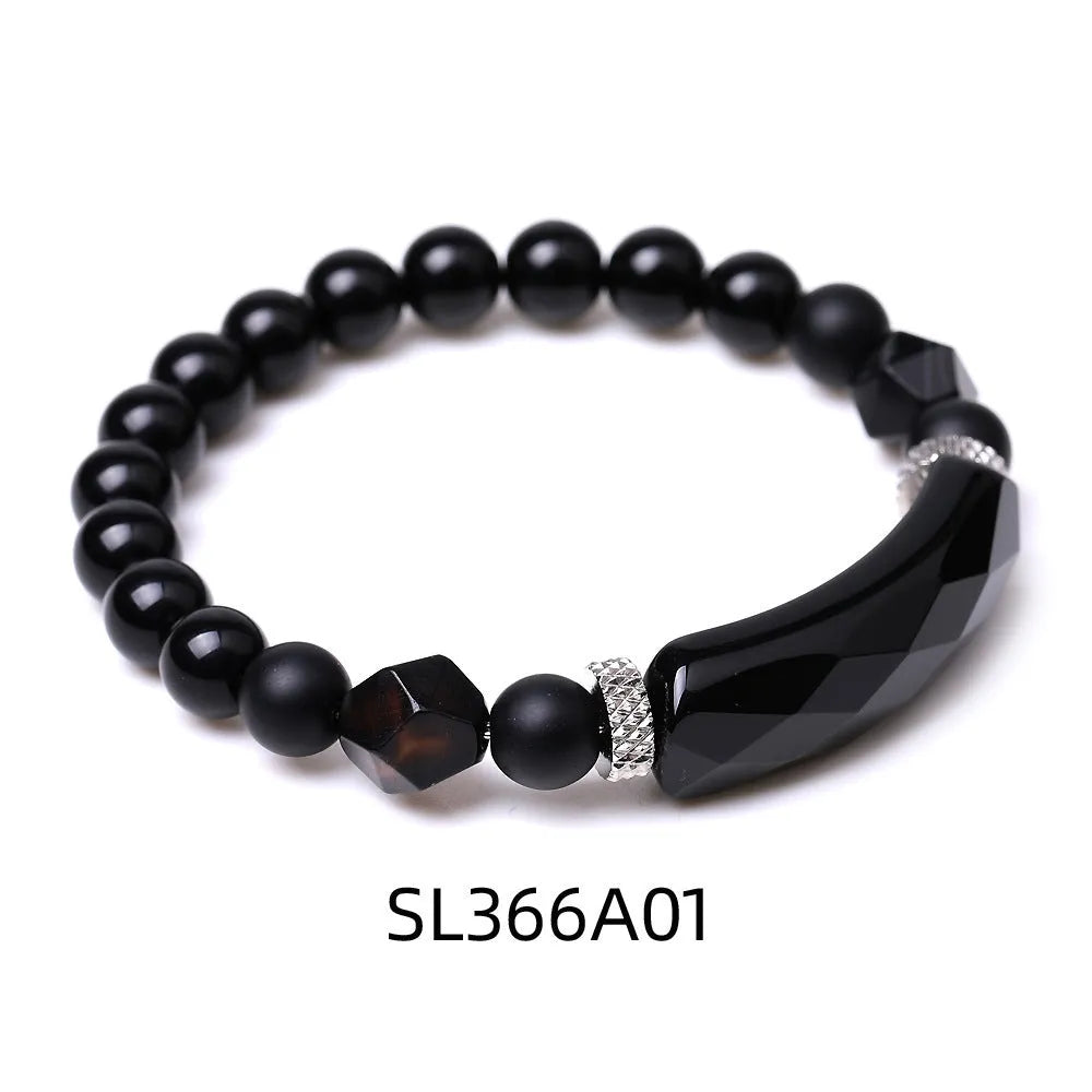Handmade diamond-shaped cut agate bracelet in a geometric, fan-shaped design on a wrist.