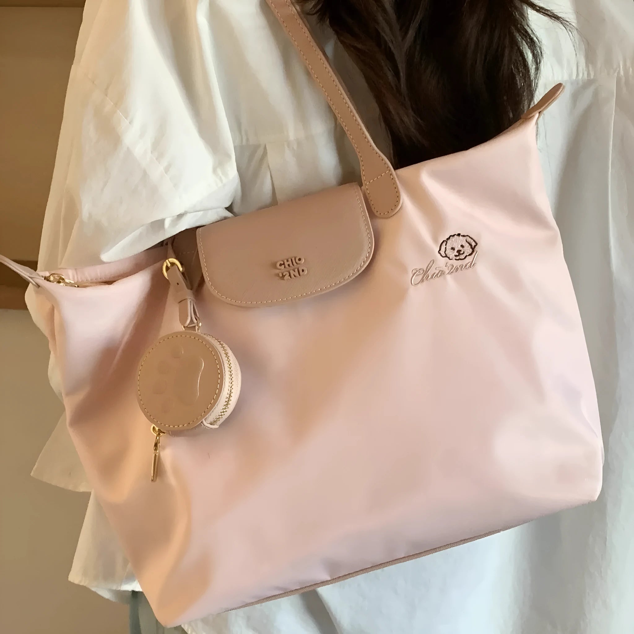 Pink Oxford cloth shoulder tote with sandwich pockets and square shape showing internal mobile phone compartment