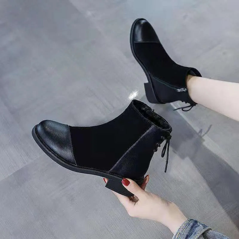 Black women's knee-high martin boots with a side zipper, round toe, and decorative bow.