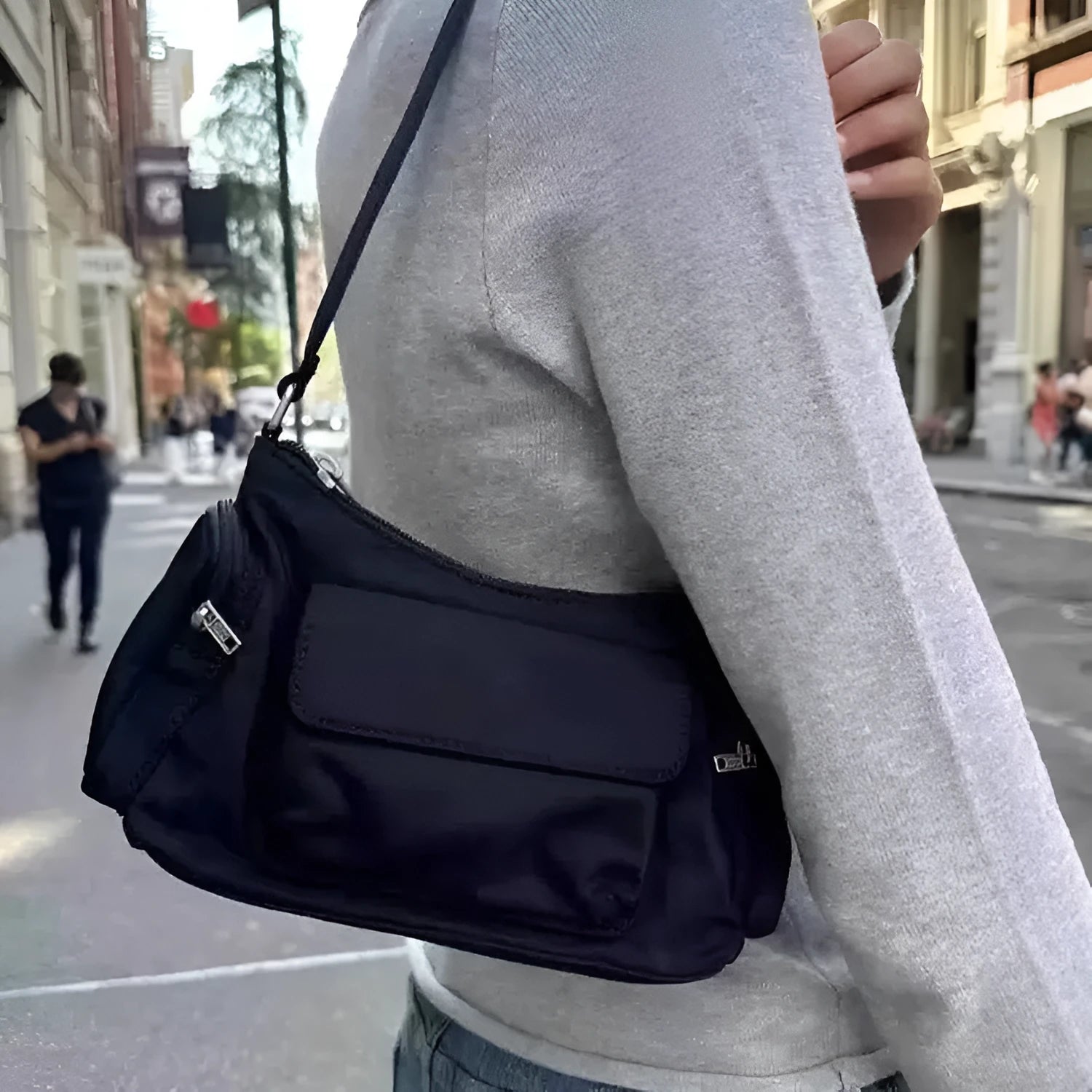 Black lightweight women's shoulder bag made of PU leather with double pockets and side line details.
