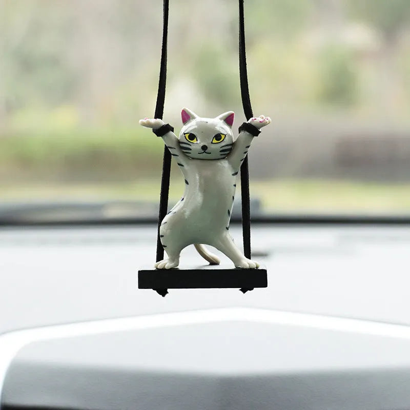 Resin cartoon cat pendant for car interior decoration on adjustable rope.