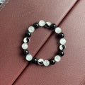 Close-up of a 10mm natural opal and black agate beaded Tai Chi bracelet for men and women.