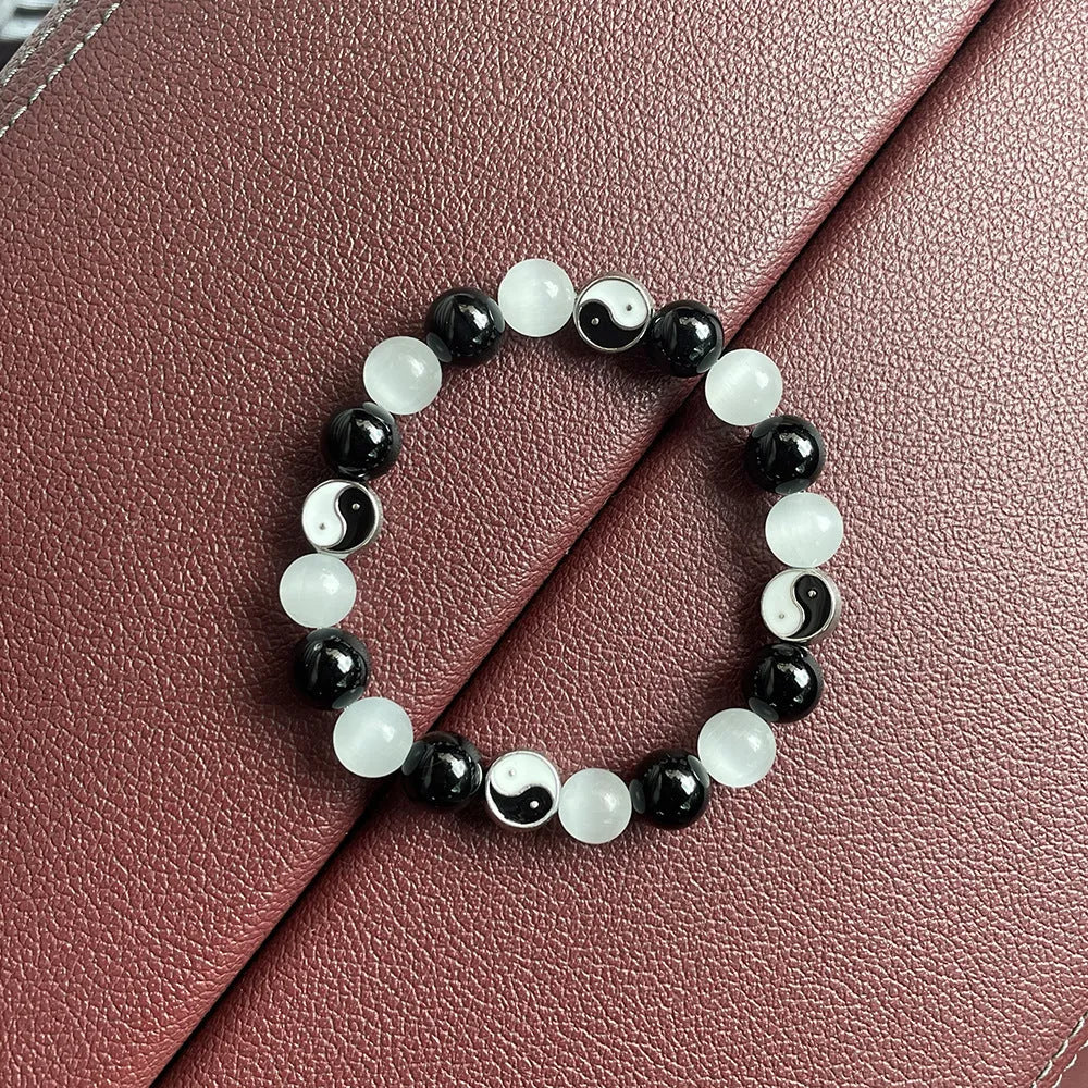Close-up of a 10mm natural opal and black agate beaded Tai Chi bracelet for men and women.