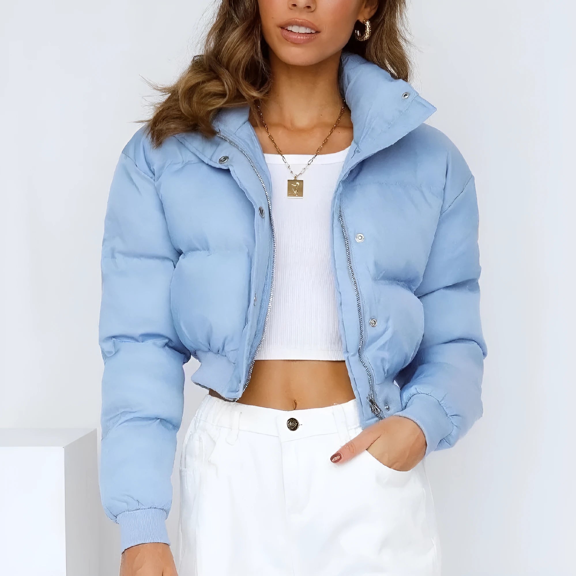 Women's loose fit blue polyester jacket with long sleeves on hanger