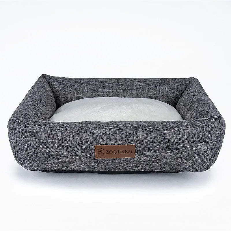 Grey plaid square cloth dog bed for medium-sized dogs on a wooden floor.
