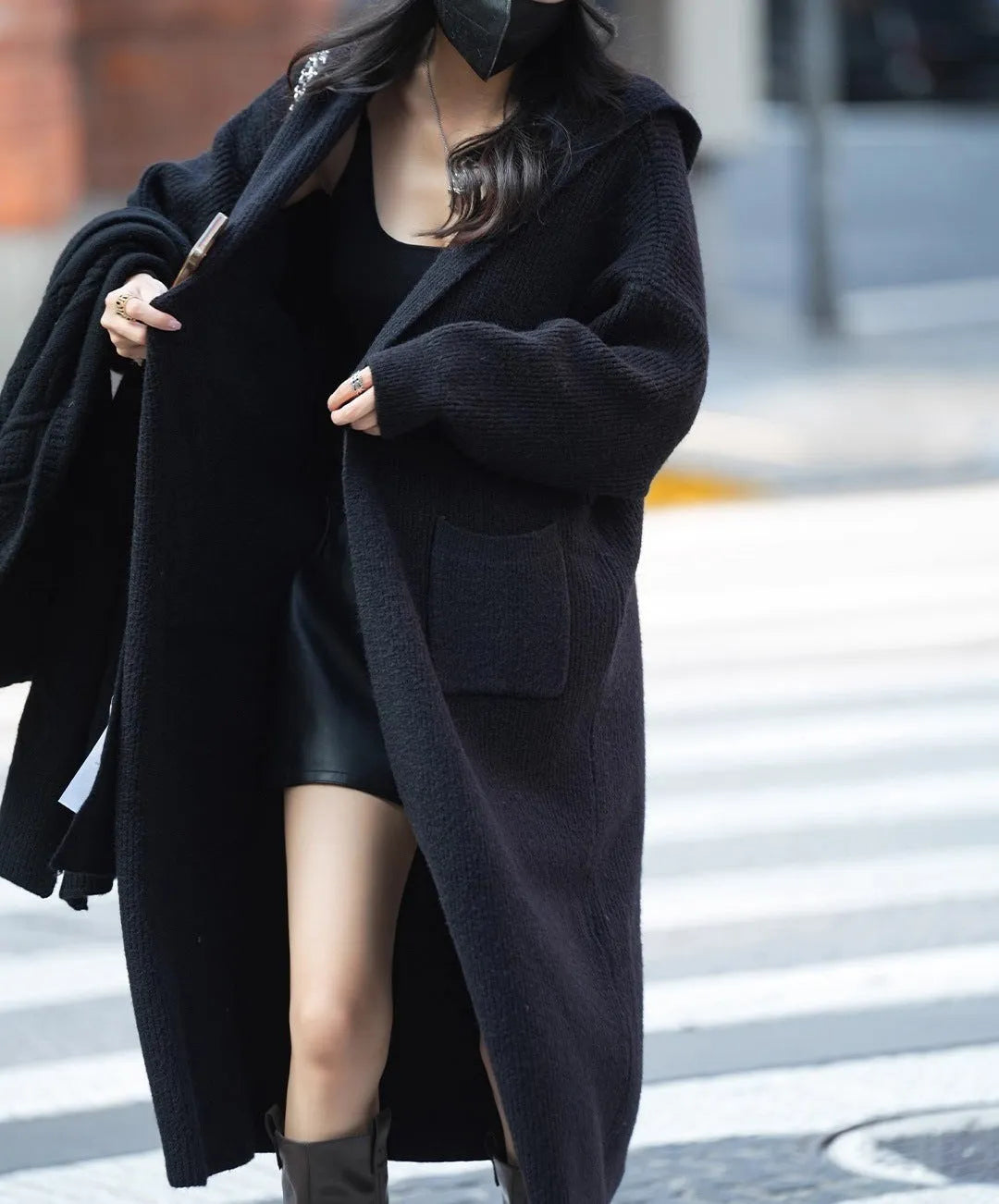 Long grey knitted hooded trench coat with a loose, cardigan-style fit and long sleeves.