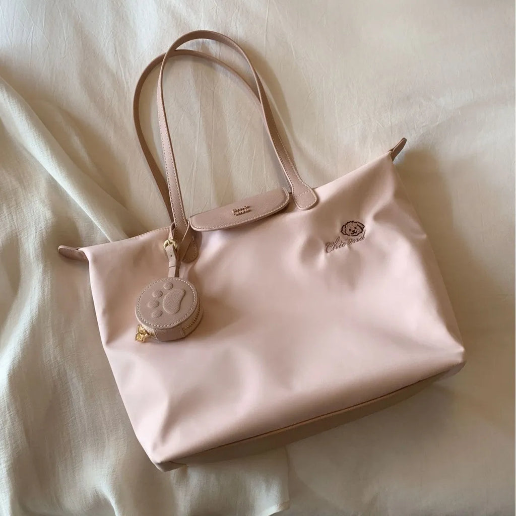 Pink Oxford cloth shoulder tote with sandwich pockets and square shape showing internal mobile phone compartment