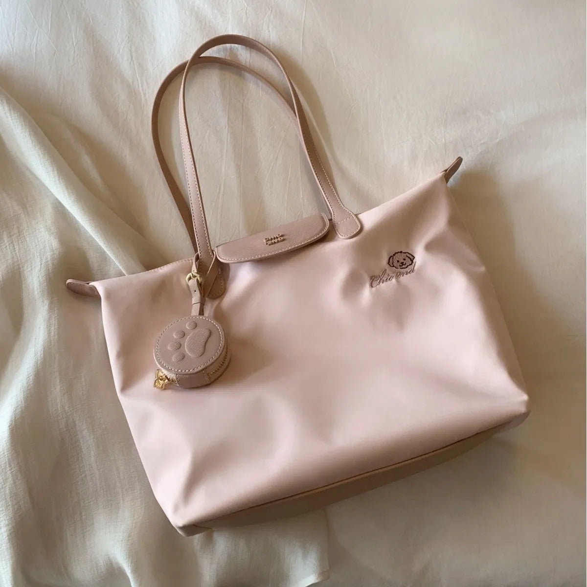 Pink Oxford cloth shoulder tote with sandwich pockets and square shape showing internal mobile phone compartment