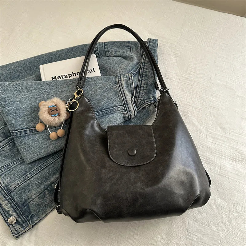 Women's PU leather shoulder bag in horizontal square shape with single strap, showing interior mobile phone compartment