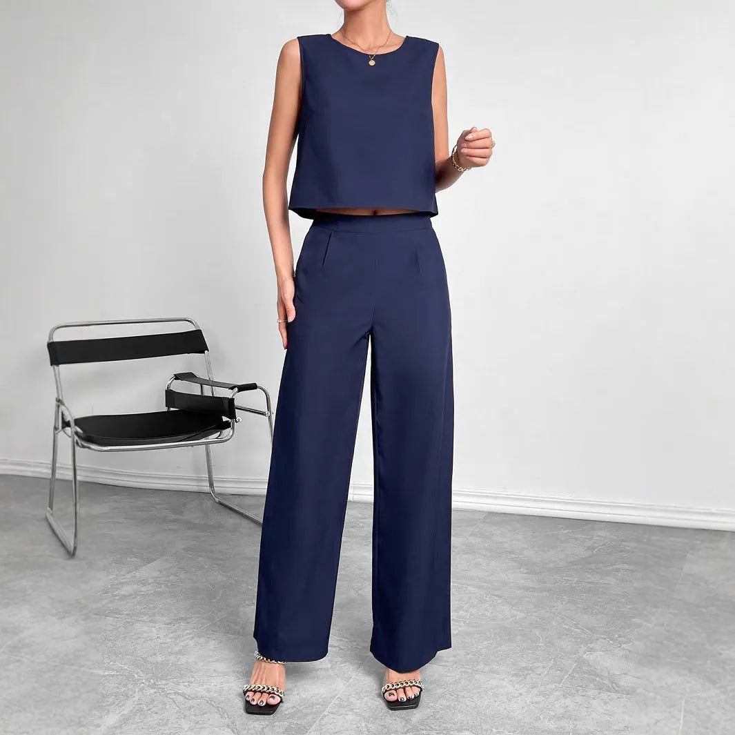 Women's red polyester two-piece set with sleeveless top and wide leg trousers on mannequin