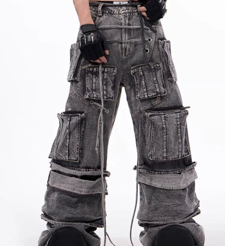 Grey distressed denim overalls for men with rope stitching on the legs and a mop pant cut.