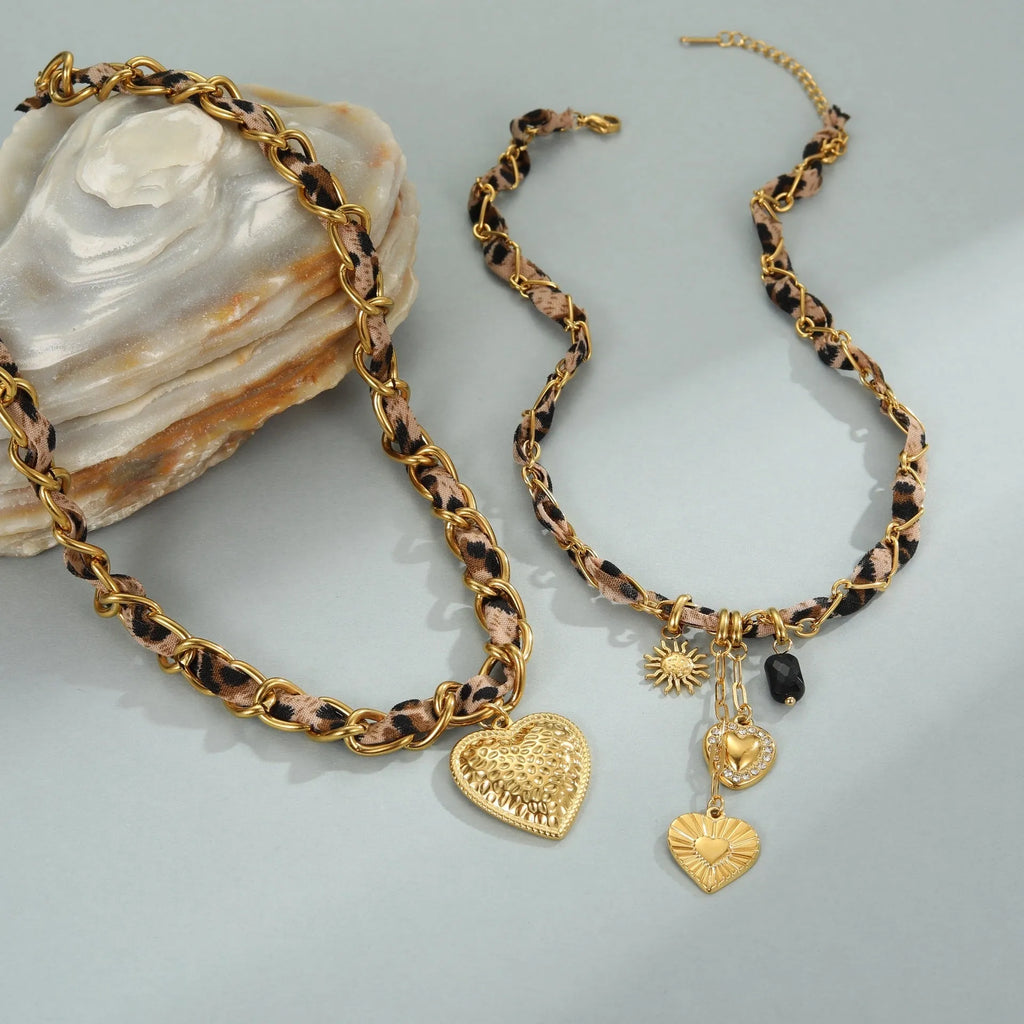 Gold-coloured stainless steel necklace with an adjustable chain and a choice of Big Heart or geometric Love Sun pendant.