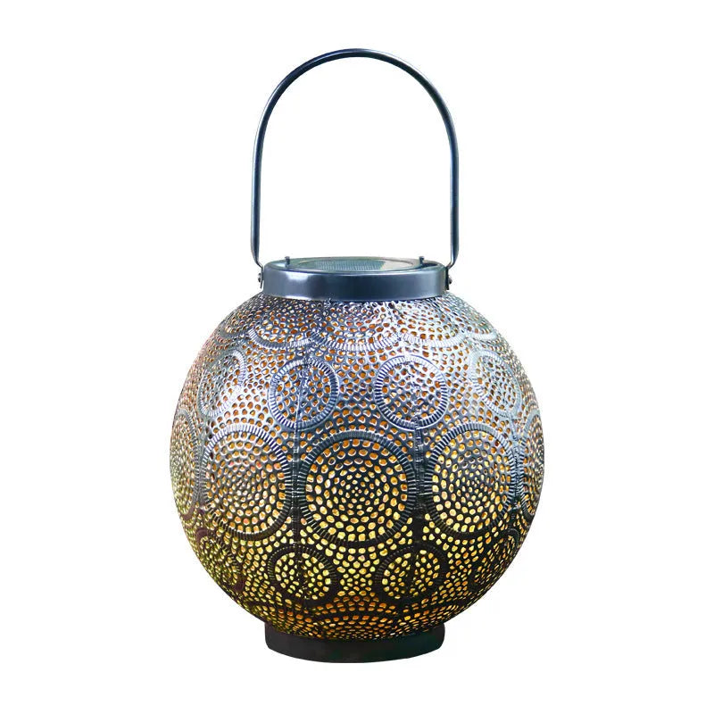 Solar courtyard lamp with hollow iron decorative design emitting warm white LED light
