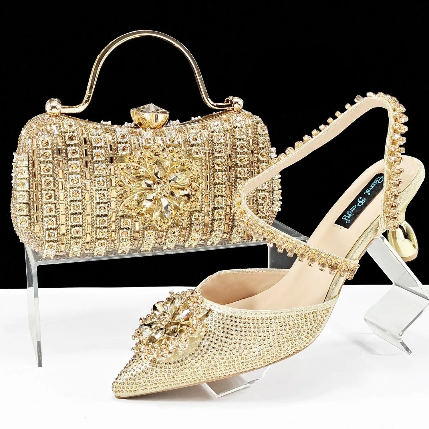 Women's high heel shoes with matching clutch bag featuring decorative flower buckle and ankle chain detail