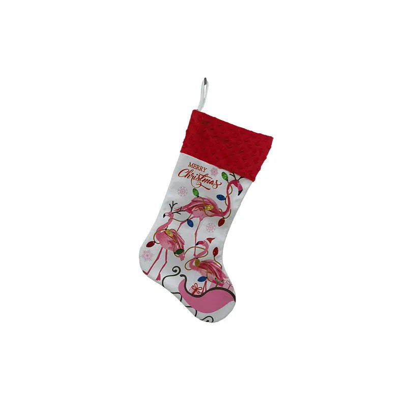 Red cloth Christmas stocking with flamingo design, 46cm long, hanging on fireplace.