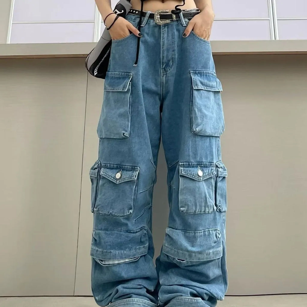 Blue tie-dyed high waist wide leg denim trousers on a woman, showing multiple pockets and street hipster style.