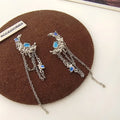 Pair of S925 silver needle moon earrings with long fringe and irregular polka dot detailing in silver tone