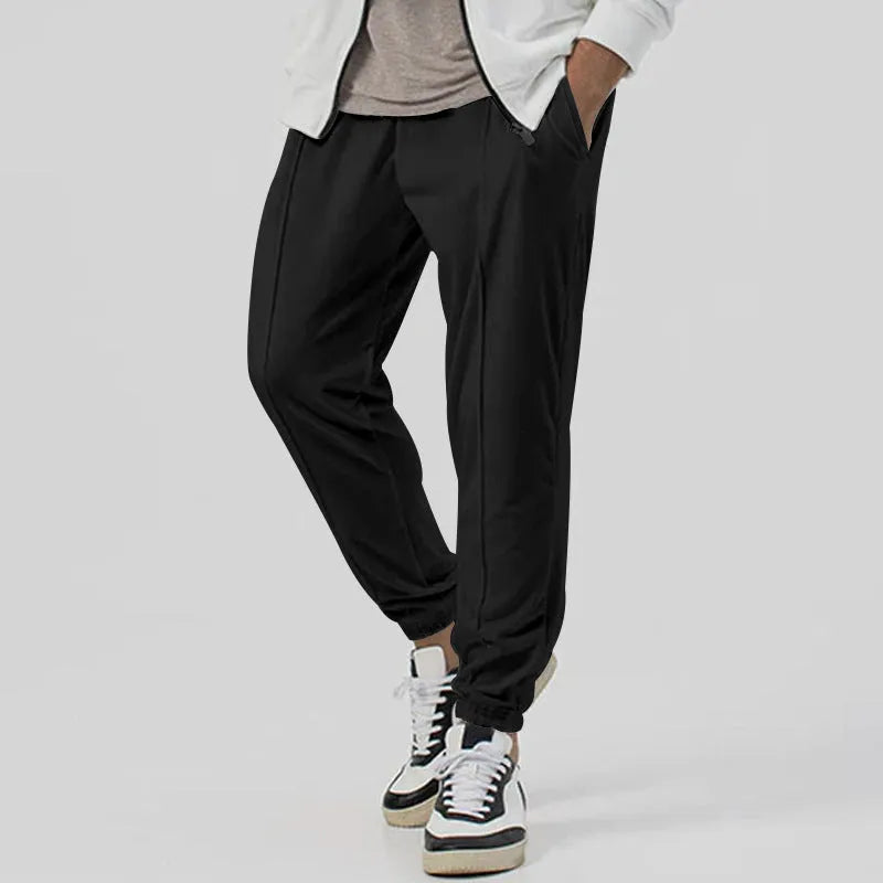 Men's grey track sweatpants with elastic waistband and straight-leg tapered fit