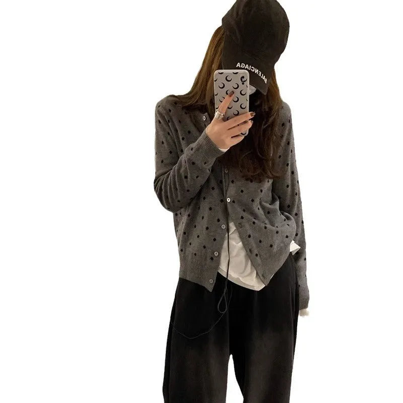 Grey Korean-style knitted cardigan with crocheted flower detail on mannequin