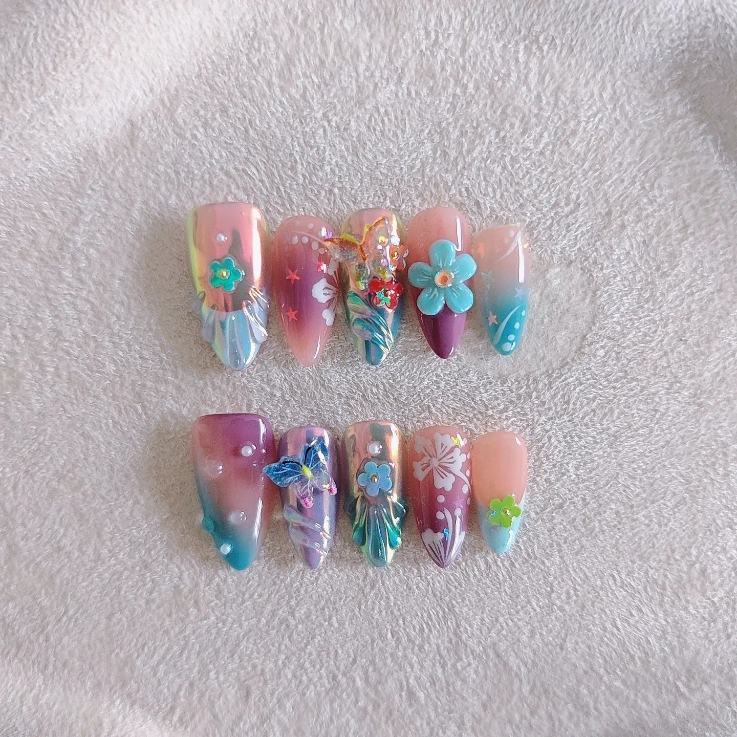 Handmade colourful nail sculpture set with small flower and butterfly designs in four sizes
