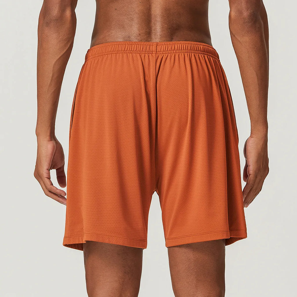 Men's double-layer quick-drying running shorts in brick red colour on a mid-waist model.