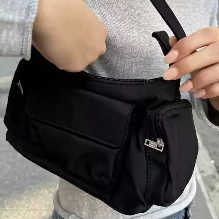 Black lightweight women's shoulder bag made of PU leather with double pockets and side line details.