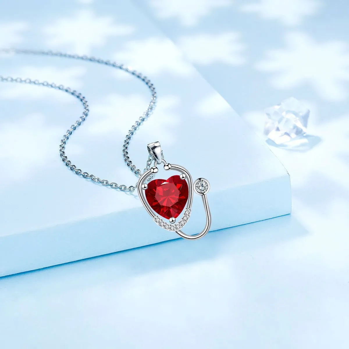 Women's fashion necklace with stethoscope and wing design in red diamond electroplated finish on copper