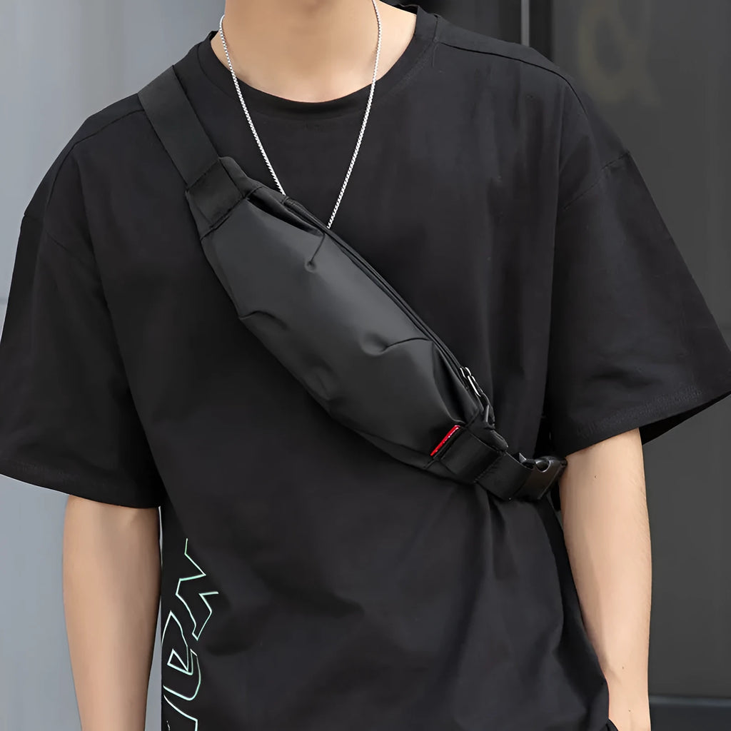 Men's black Oxford cloth crossbody waist pack showing interior phone and ID pockets