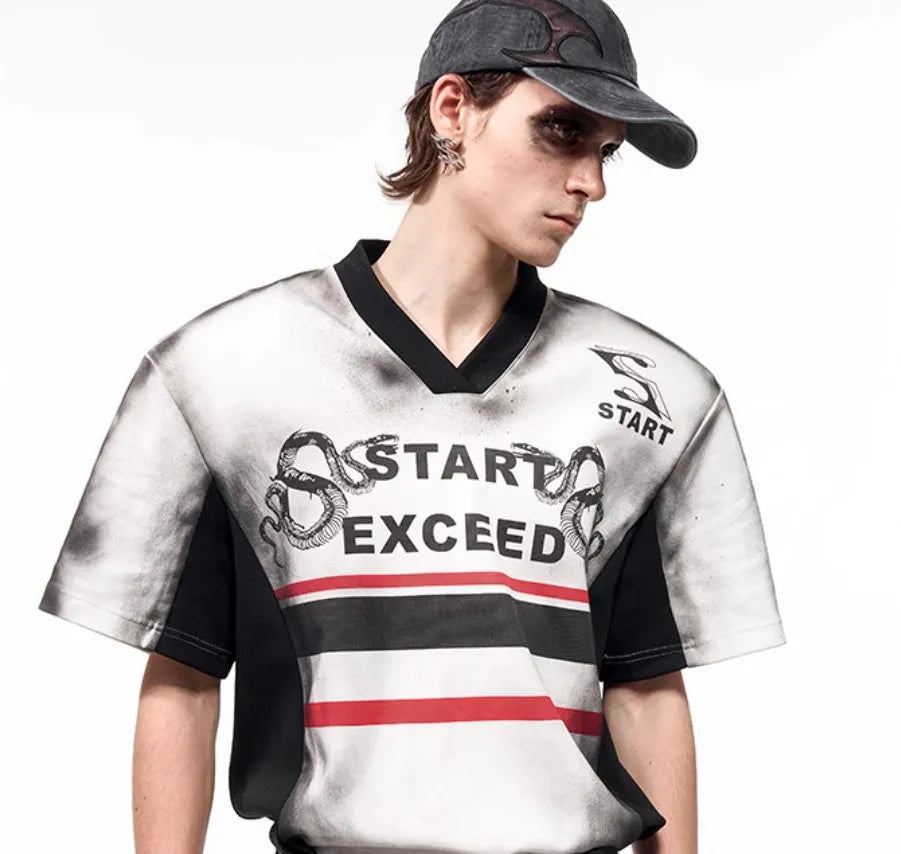 Women's V-neck short sleeve top with a black and white letter snake pattern print and padded shoulders.