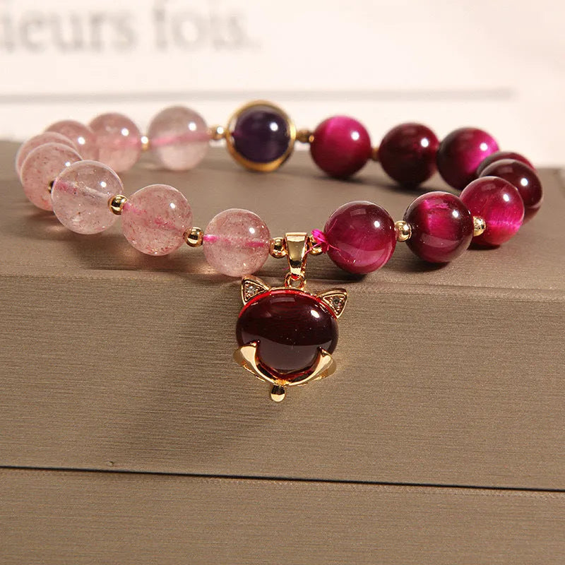 Strawberry crystal bracelet with elastic rope on wrist showing 18cm circumference