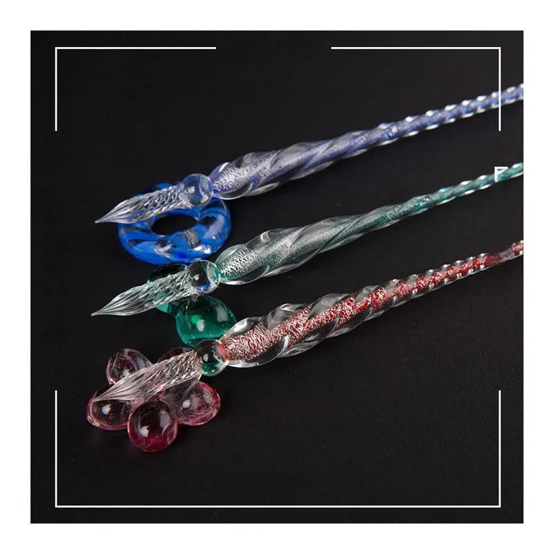 Hand-blown glass crystal pen with coloured ink in a transparent barrel on a gift box.
