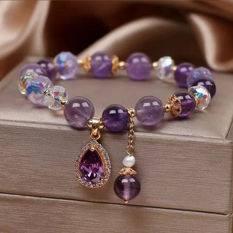 Close-up of a women's purple amethyst crystal bracelet with detailed micro inlay stone setting.