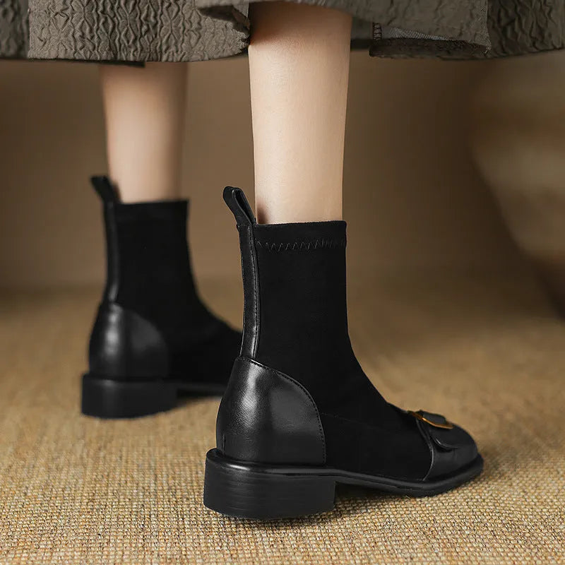 Women's black casual low-heel ankle boots with belt buckle detail and front lace-up closure.