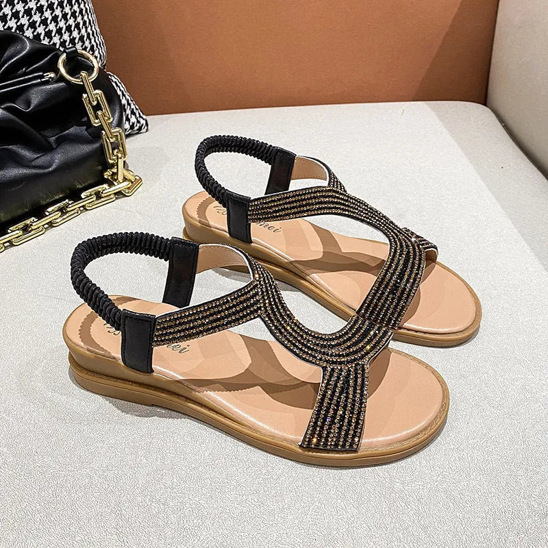 Gold women's patent leather sandals with rhinestone decoration and a non-slip sole.