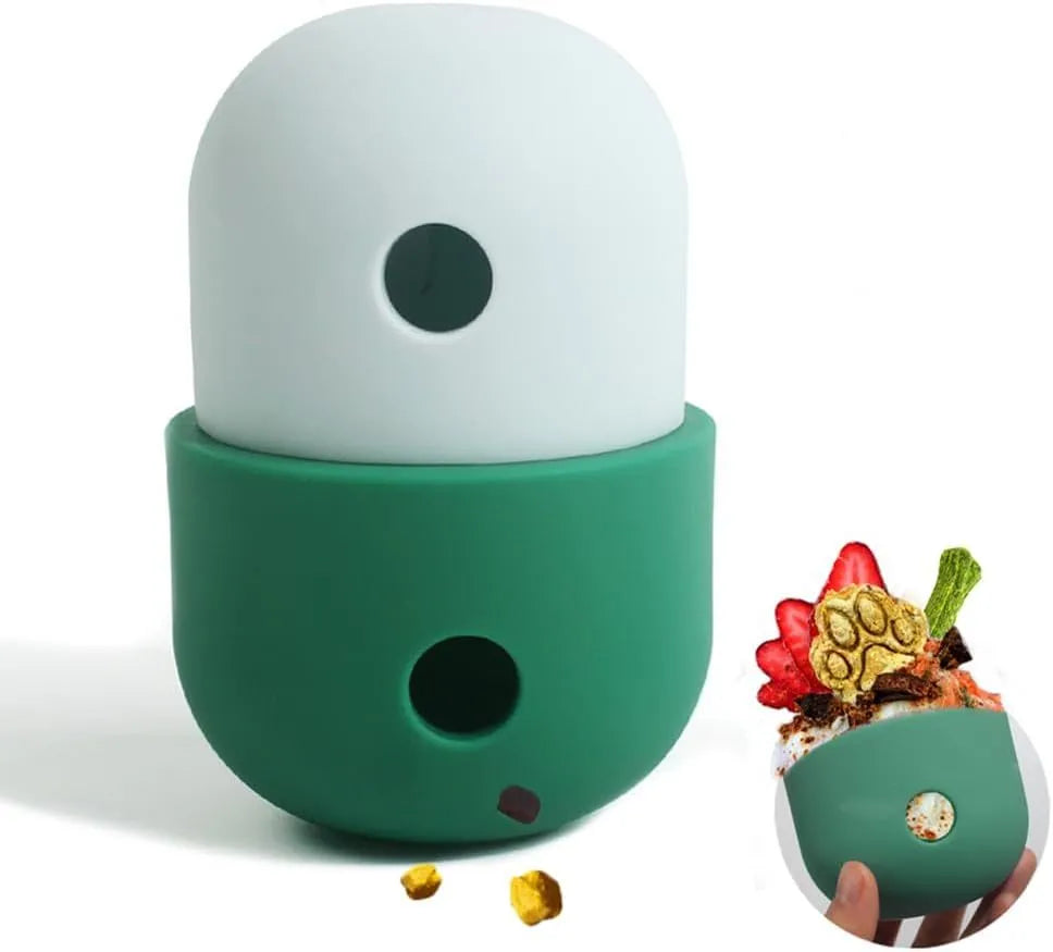 Two-tone silicone dog treat dispensing puzzle ball for small medium dogs on a wooden floor