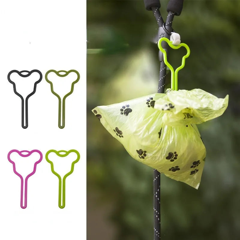 Hands-free dog poop bag holder with black velcro strap and clip attached to a dog leash.
