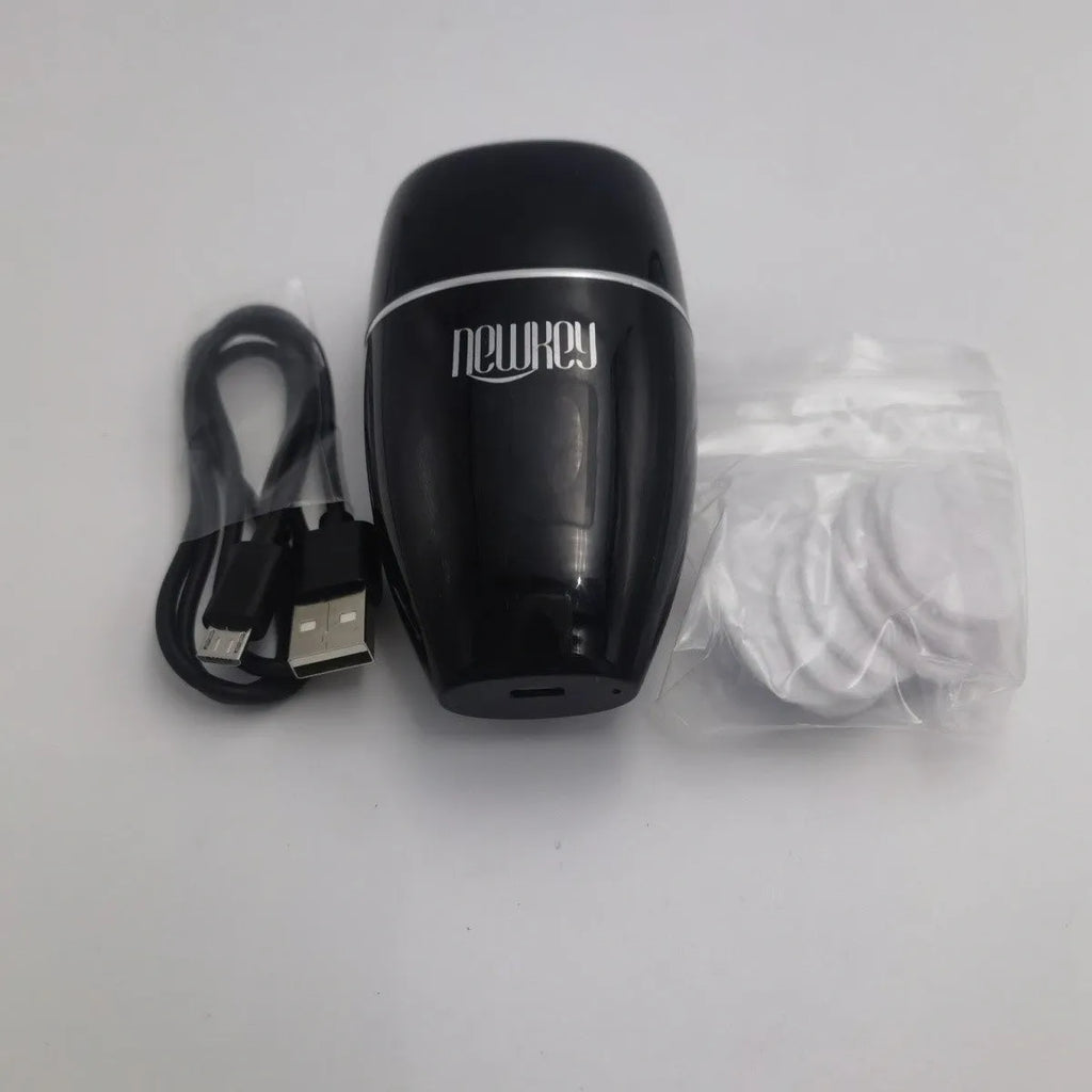 Black and white electric silicone lip plumper device with USB cable.