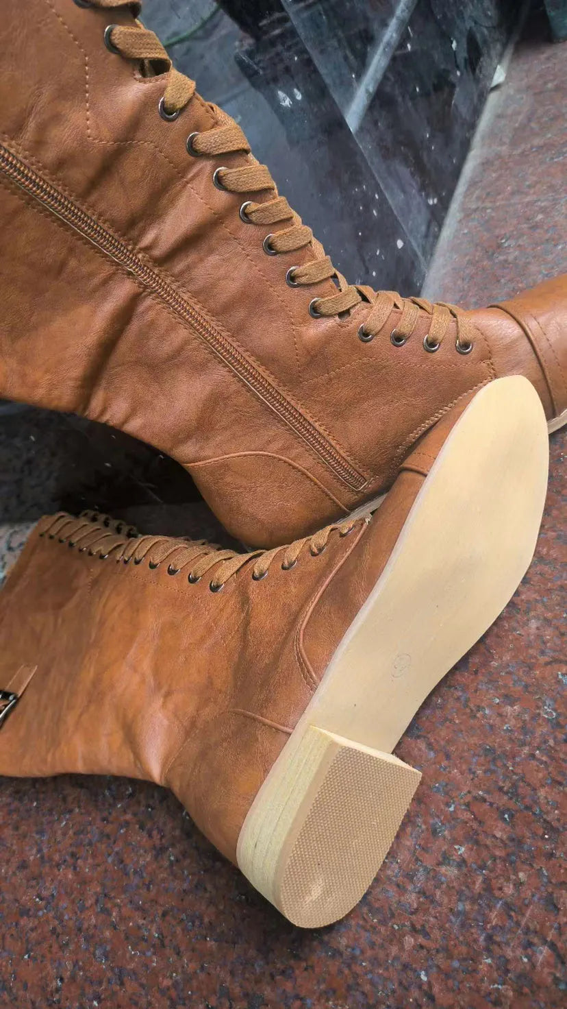 Women's black artificial PU knight boots with cross straps and buckle fastenings.