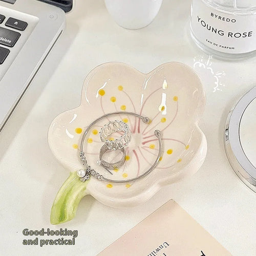 Yellow ceramic ornament tray with a small pink-shell night light placed on it, modern simple style.