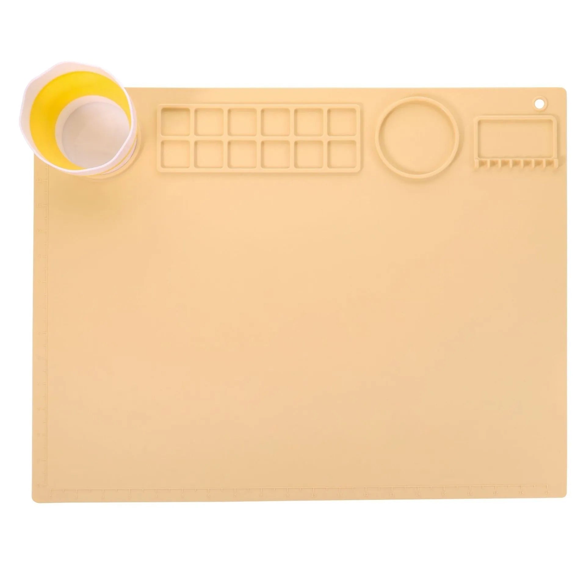 Light blue silicone painting mat with two mixing bowls, measuring 50cm by 40cm on a wooden table.