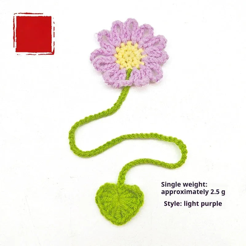 Hand-crocheted wool bookmark with flexible wire core and little daisy design in milk cotton yarn