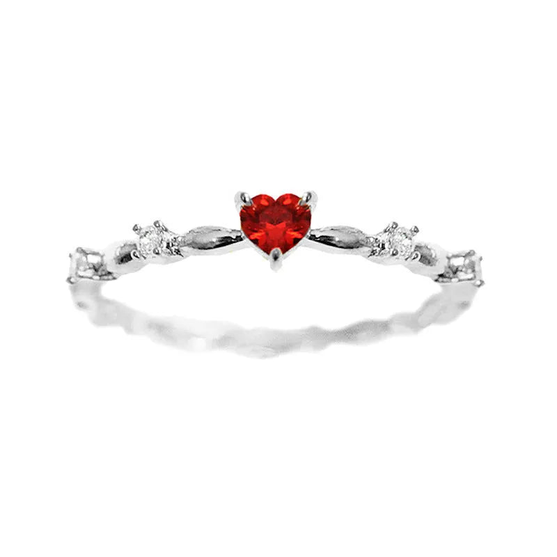 Gold tone peach heart ring with zircon stone centre on finger