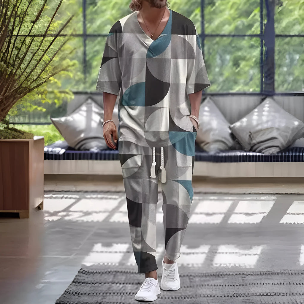 Thin polyester trousers suit with V-neck cropped sleeve jacket and matching trousers on a hanger.
