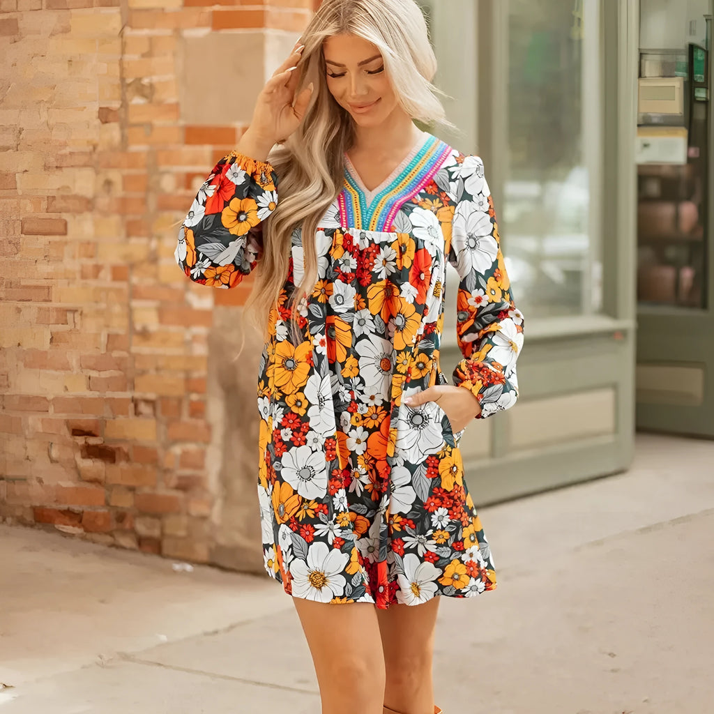 Orange floral print striped lace V-neck long sleeve mini dress on a hanger