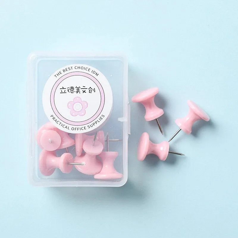Plastic push pins in mint green, lavender, and pink, showing large and small sizes in a small box.