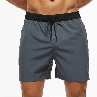 Men's blue fitness shorts with stitched waist headband, drawstring, zipper pocket, and padding for running