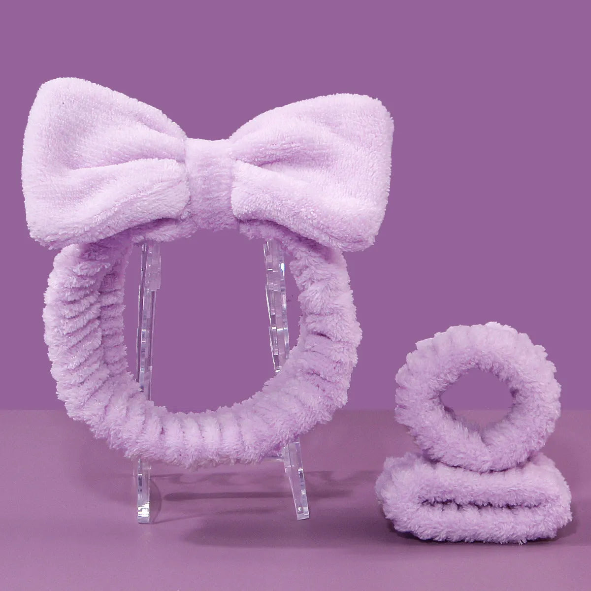 Facial brush and coral fleece hair band set in purple colour with plastic handle and nylon bristles